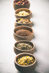 Assortment of dry tea in coconut bowls.
