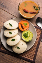 Idly sambar or Idli with Sambhar and green, red chutney. Popular South indian breakfast