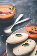 Idly sambar or Idli with Sambhar and green, red chutney. Popular South indian breakfast