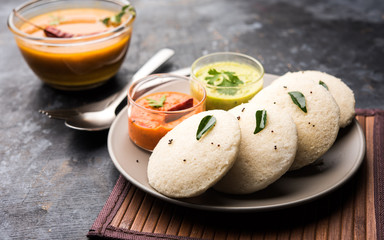 Idly sambar or Idli with Sambhar and green, red chutney. Popular South indian breakfast