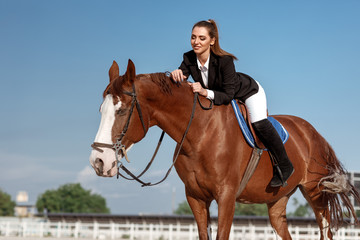 Rider elegant woman riding her horse outside