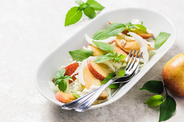 Healthy pear and shaved fennel salad with lemony dressing. Selective focus, space for text.