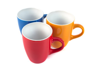 Three color ceramic cups on a white background