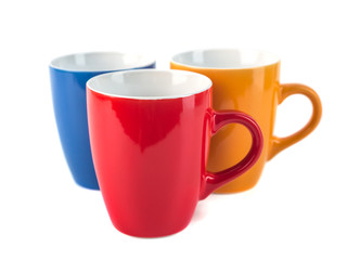 Three color ceramic cups on a white background