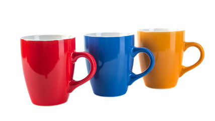 Three color ceramic cups on a white background