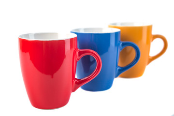 Three color ceramic cups on a white background
