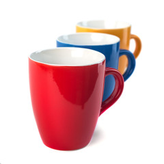 Three color ceramic cups on a white background