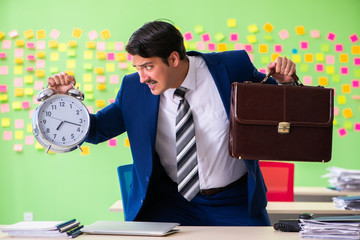 Businessman with many conflicting priorities in time management 