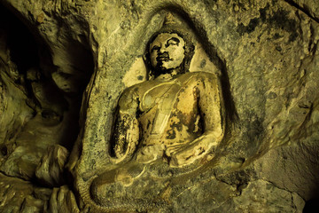Amazing ancient Buddha statue on the wall of Thailand cave.