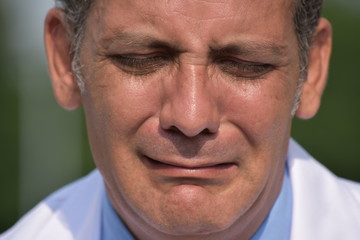 Depressed Male Surgeon Wearing Lab Coat