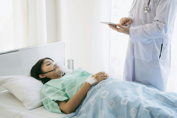 doctor is checking the patient information , Severe illness on Patient's bed at hospital