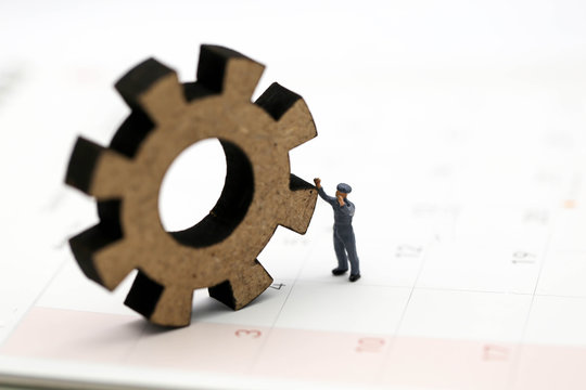 Miniature people : Worker and tool with Calendar Using for concept Calendar Adjustment Day.