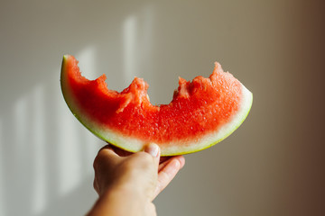 Person holding bite watermelon