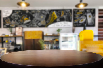 Selected focus empty brown wooden table and Coffee shop or restaurant blur background with bokeh image. for your photomontage or product display