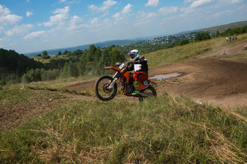 A picture of a biker doing a trick, and jumping into the air. Motocross Championship. sports fast driving. bike large small.