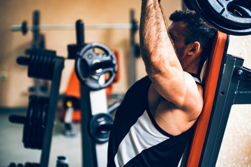 Athlete does deltoid exercises on hammer machine