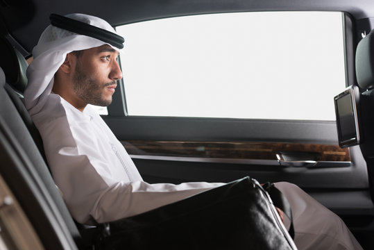Emirati businessman traveling in car.