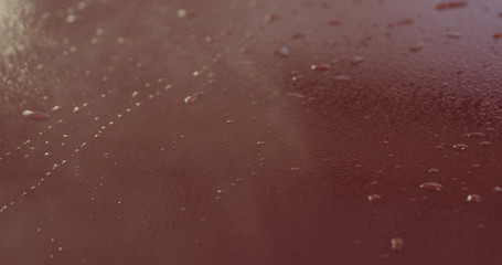 Closeup focus red car wash degreasing paint soak