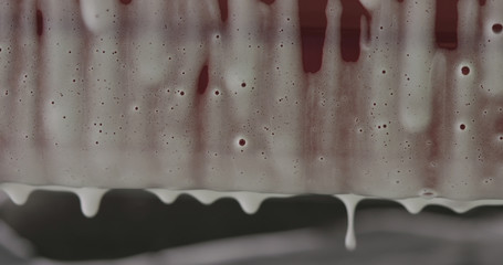 closeup of foam dripping off the car on car wash
