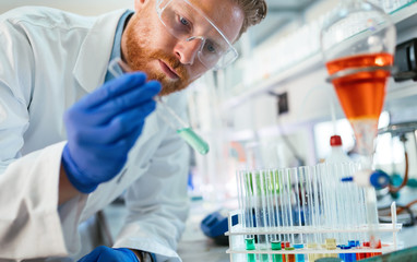 Handsome student of chemistry working with chemicals