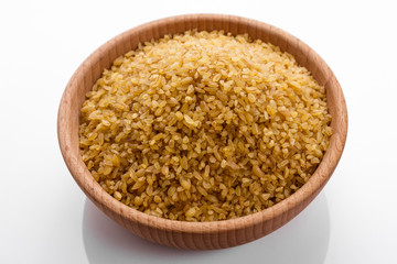 raw bulgur on a white acrylic background