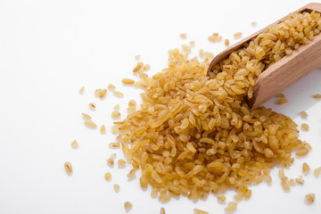 raw bulgur on a white acrylic background