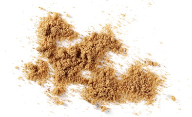 Unrefined brown cane sugar pile isolated on white background, top view