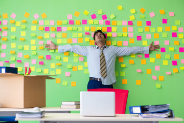 Man collecting his stuff after redundancy in the office with man