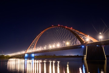 Fototapeta na wymiar Bridge over the river Ob night. The lights of the bridge glow in the night sky. 