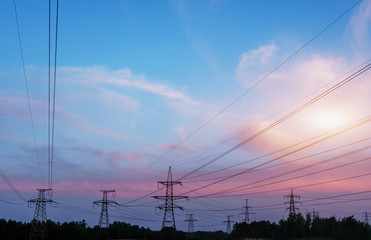 high-voltage power lines at sunset. electricity distribution station .