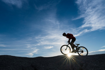 Naklejka na ściany i meble Young man riding mountain bike