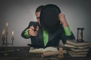 Detective spy agent holding in hands a gun and is aiming. Detective or spy agent or police...