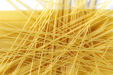 Spaghetti, yellow pasta isolated on white background, top view