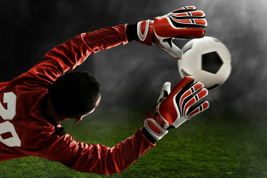 Fototapeta Soccer goalkeeper catches the ball