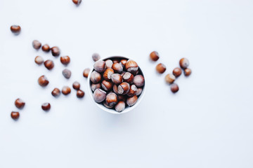 Top view of group of hazelnuts and dropped hazelnuts in the background