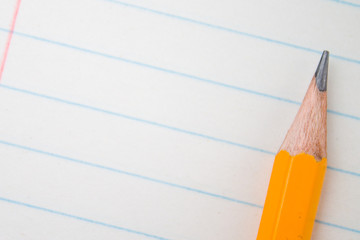 Back to school, education concept with orange pencils close up and composition book on background for educational new academic year begin or study term start. Mock-up Copy space