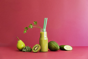 Healthy detox smoothie with green vegetables and fruit lie on the red table. Copy space, red backgrounds wall. 