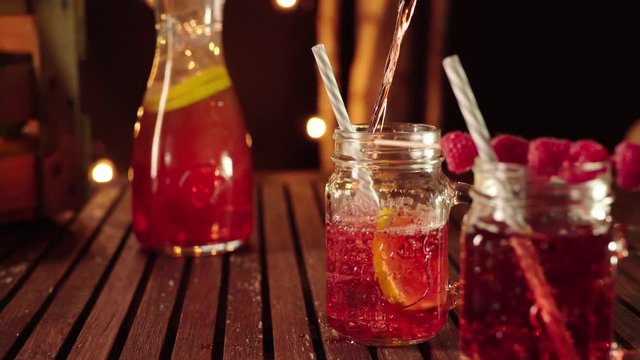 Filling fresh homemade lemonade in a mason jar glass