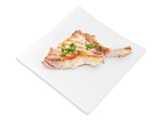Grilled pork loin chop on white square dish