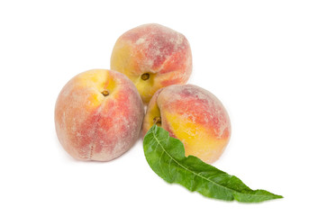 Three fresh peaches on a white background