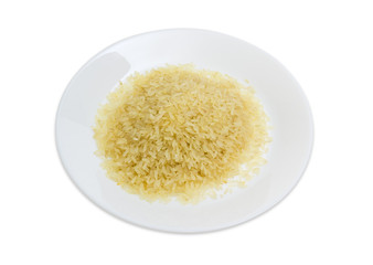 Uncooked parboiled rice on the white dish on white background