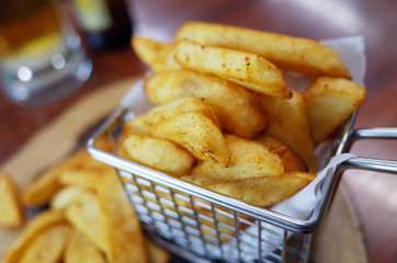 Close up of French fries on wooden table