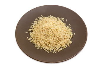 Uncooked brown rice on the brown dish on white background