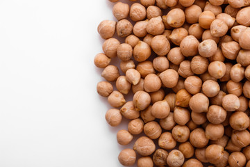 uncooked chickpeas on a white acrylic background