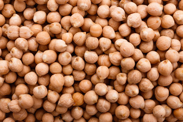 uncooked chickpeas on a white acrylic background