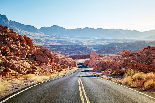 Scenic desert road at sunset, travel concept, USA.
