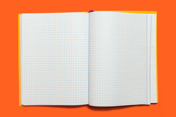 white opened workbook lying on an orange background. concept of business or educational equipment....
