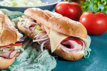 Submarine sandwiches with ham, cheese and vegetables