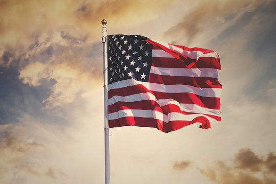 american flag waving in the sky, toned wth instagram filter