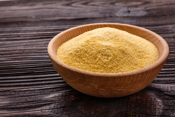 raw Italian corn porridge polenta on a rustic wooden background